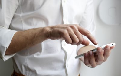 person holding white Android smartphone in white shirt